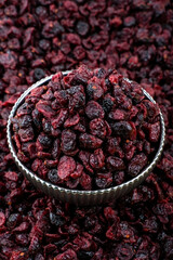 Close-Up View of Dried Cranberries in a Metal Bowl, A high-resolution image featuring a close-up view of dried cranberries filled in a rustic metal bowl, showcasing rich textures and vibrant red color