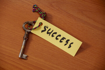 Key with success written on paper
