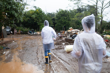 volunteers wearing raincoats taking donations to families affected by floods in southern Brazil