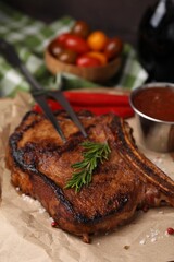 Tasty marinated meat, rosemary and spices on parchment, closeup