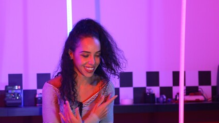 Close up of hispanic street dancer practicing street dancing at studio with purple led light....