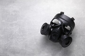 One gas mask on grey textured background, top view. Space for text