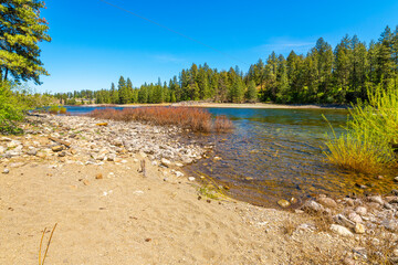 View from a small sandy beach along the Spokane River at the public McGuire Park, in Post Falls, Idaho, a neighboring city and considered part of the general Coeur d'Alene region of North Idaho.