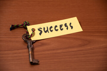 Key with success written on paper