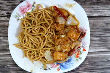Asian food, Traditional Chinese food cuisine of grilled chicken breast pieces, sweet and sour chicken with vegetables, Chinese noodles classic spaghetti pasta macaroni with onions and soy sauce