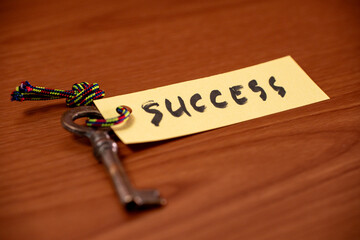 Key with success written on paper