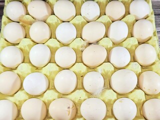 Pile of organic and natural fresh and raw hen chicken eggs, stack of eggs ready to be cooked in...