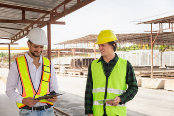 Engineer and foreman worker team checking project at precast factory site, Engineer and builders in hardhats discussing on construction site