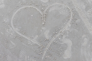 A heart drawn in sand on a beach in Galveston, Texas.