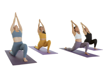Young women doing Virabhadrasana 1 pose, while practicing yoga in a studio in Mexico City