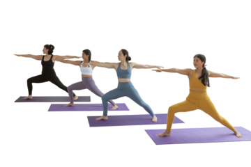 A group of women in yoga class doing the warrior pose