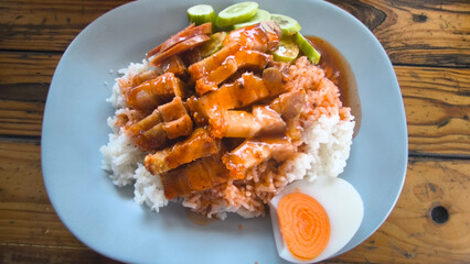 Crispy pork rice on a blue plate on the dining table