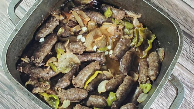 Middle Eastern cooked beef sausage, Egyptian sausages with green peppers, onion, garlic, tomato, black pepper and oil, it is a dry, spiced sausage either beef or lamb consumed in Middle East