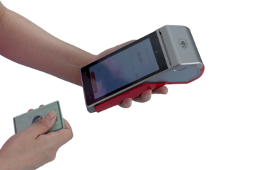 A woman's hands hold a payment terminal and a card to make a charge, with copy space