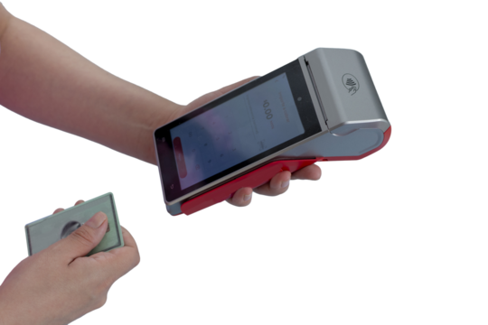 A woman's hands hold a payment terminal and a card to make a charge, with copy space