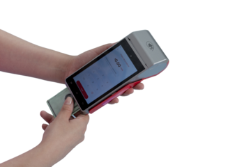 Woman's hands making a card payment at a payment terminal, with copy space