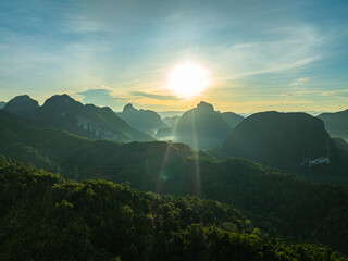 aerial hyper lapse view Amazing light of nature cloudscape above mountain range in Phang Nga. .High peaks wonderful morning sunset natural Landscape. .Beautiful sunset tropical landscape background..