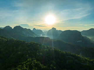 aerial hyper lapse view Amazing light of nature cloudscape above mountain range in Phang Nga. .High peaks wonderful morning sunset natural Landscape. .Beautiful sunset tropical landscape background..