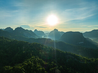 aerial hyper lapse view Amazing light of nature cloudscape above mountain range in Phang Nga. .High peaks wonderful morning sunset natural Landscape. .Beautiful sunset tropical landscape background..