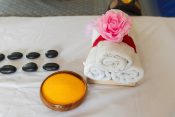 spa massage wellness decorations setting on wood table. thai spa massage traditional compress for hot massage and spa relaxing treatment of office syndrome. massage for health concept.