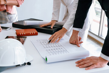 Architect and engineer working with construction drawing project on table in office. Architecture...