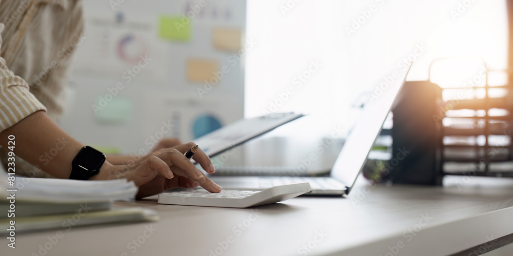 Poster accountant, bookkeeper using calculator to calculate financial report . account and allocating compa