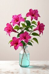a bouquet of freshly cut bougainvillea flowers placed in a clear glass vase on a white tabletop - obrazy, fototapety, plakaty