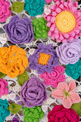 A colorful crochet flower arrangement with a variety of colors and shapes
