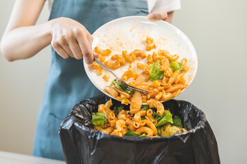 Compost from leftover food asian young housekeeper woman, girl hand holding macaroni plate use fork...