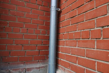 red brick wall with a hole