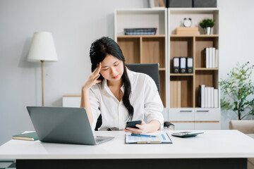 Asian business woman is stressed, bored, and overthinking from working on a tablet