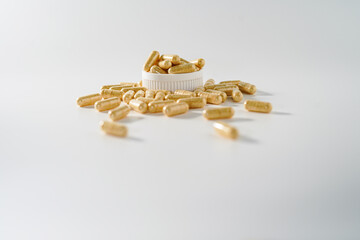 White medicine capsules, yellowish white pills