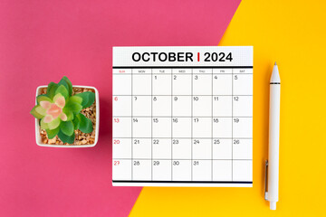 White calendar for October 2024 and pen on beautiful background.