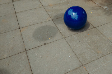 blue rubber ball on cement floor