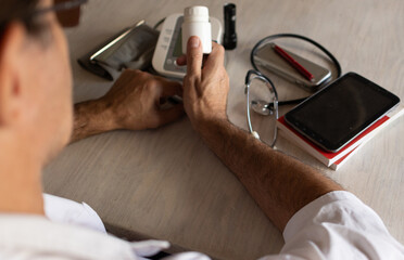 Photo taken from above of a doctor working at his desk.,attending to patients.Health care concept