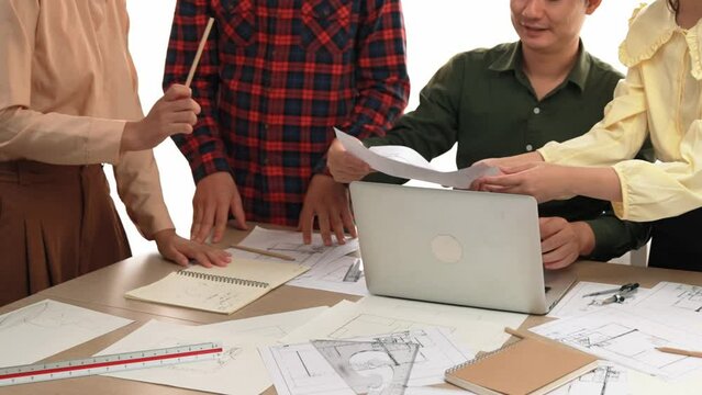 Architect and safety engineer celebrate success design building blueprint project on laptop with architectural document and measurement tool scatter around at modern office. Closeup. Delineation.