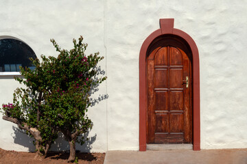 wood entrance door to a Mediterranean villa, rough texture wall