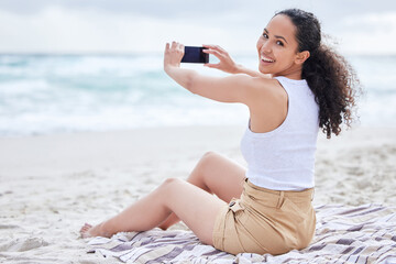 Beach, smile and portrait of woman with phone for holiday, travel blog and photography of ocean. Happy, photographer and picture with smartphone on sand for adventure, social media post and update