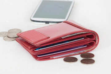 red wallet money, coins and mobile phone of lifestyle woman arrangement flat lay style on...