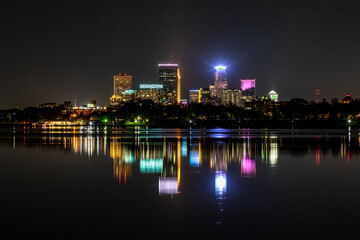 Minneapolis skyline at night reflecting off the waters of Lake Bde Maka Ska in Minnesota on a clear summer night © Rob Schultz