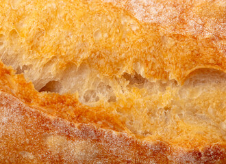 Ruddy crust of bread as an abstract background. Texture