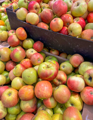 Ripe red apples on a counter in a market as a background. Texture