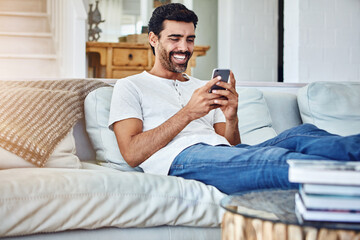 Happiness, man and smartphone on sofa for texting, communication or notification in living room. Online, connection and male person with mobile phone for social media, networking or internet in home