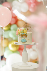 Birthday cake decorated with cream, gingerbread and chocolate balls