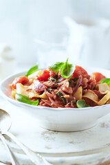Pappardelle Pasta with Vegetables and fresh Basil on bright wooden Background	