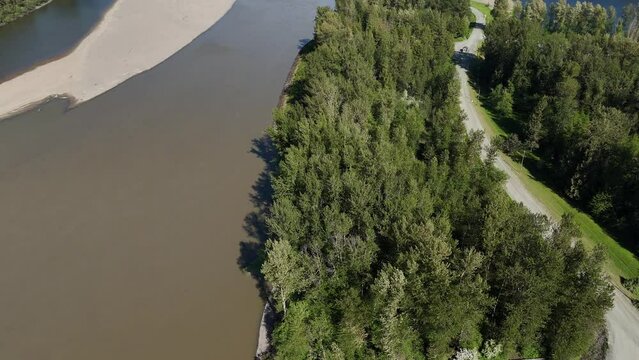 Aerial view (tilt up) of the Island 22 Regional Park along Fraser River in Chilliwack, British Columbia, Canada