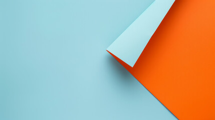 Minimalist Design Featuring an Orange Paper Folded Over a Light Blue Background, Emphasizing Clean Lines and Contrasting Colors
