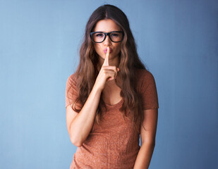 Girl, glasses and finger for secret on studio backdrop, mock up and hush sale with optometry...