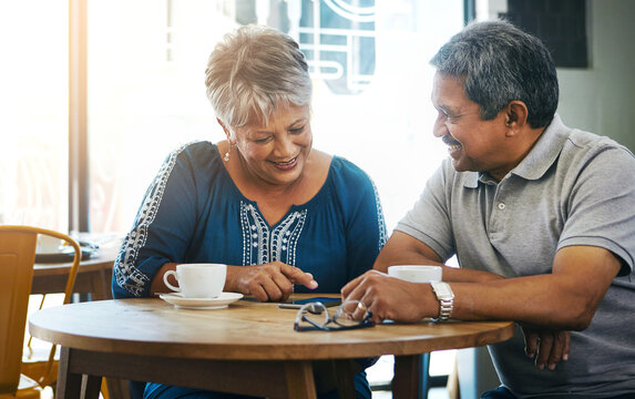 Senior couple, phone and happy in cafe for date with online news, social media post and reading information. Elderly, people and smartphone in coffee shop with smile for bonding, retirement and relax