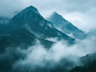 Majestic Misty Mountain Peaks Shrouded in Ethereal Clouds and Atmospheric Serenity